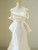 Strapless bodice with architectural pleats on an ivory wedding dress that feels modern and timeless