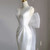 Zipper back on white satin V-neck wedding dress with bow detail