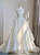 White organza strapless wedding dress with a full A-line skirt and a train, a light and airy choice for a grand entrance