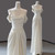 Off-shoulder draped sleeves and waist pleats on simple ivory satin wedding dress