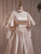 Long sleeve with lace trim on champagne satin A-line bridal gown
