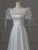 Close-up of structured square neckline on a vintage-inspired satin wedding dress.