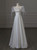 Romantic square neckline wedding dress with puff sleeves, satin fabric, and pearl embellishments.