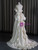 Bridal back view showcasing the open back design with delicate bow details along the spine and the graceful satin train of an ivory wedding gown.