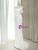 Side profile of a white satin mermaid wedding dress showing the fitted silhouette and floor-length hem.