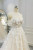 lose-up of off-the-shoulder neckline with intricate lace appliqués on a boho wedding gown.
