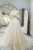 Detailed floral lace appliqués cascading down the bodice of a tulle wedding dress.