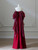 Strapless sweetheart neckline and pleated bodice on formal burgundy gown