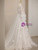 Lace up back detail on a white tulle prom dress with long sleeves