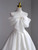 Lace-up back detail on a satin bow wedding dress.
