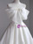 Close-up of the statement satin bow on a modern white wedding dress.
