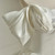 Close-up of beading and sparkle details on a white satin bridal gown