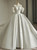 White satin ball gown wedding dress with off-the-shoulder sleeves and beading
