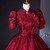 Close-up of floral jacquard fabric and the bow embellishment on a formal evening gown