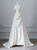 Ivory white off-the-shoulder satin wedding dress with pearl details and A-line skirt