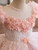 Close-up of delicate 3D flowers and sequins on the bodice of a pink tulle flower girl dress