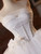 Close‑up of intricate beading and sequin details on the bodice of a white tulle strapless wedding dress