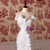 Close-up of intricate pleats on the bodice and hi-lo skirt of a white strapless mermaid wedding dress