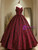 Close-up of rose print pattern on burgundy Quinceanera ball gown