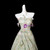 Close-up of pastel floral appliques on strapless green tulle prom dress