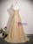 Lace-up back detail on a gold sequin prom dress, showing the fitted bodice and flowing A-line skirt