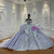 The layered imperial purple tulle skirt provides a voluminous foundation for the intricate beadwork, creating a silhouette of regal proportion and grace.