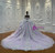 The back of this lavender gown features a lace-up corset and a continuation of the beaded floral appliqués, the full tulle train flowing like a gentle evening breeze.