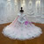 The layered pink tulle skirt provides a soft, voluminous foundation for the intricate embroidery, creating a silhouette that's both grand and gracefully refined.