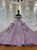 A super luxury pink ball gown that commands the room — its off-shoulder bodice shimmering with crystal sequins and floral appliques, the full tulle skirt pooling like a cloud.