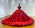 Close-up of shimmering sequin embellishments on red tulle one shoulder prom dress