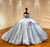 Close-up of handcrafted 3D tulle flowers on blue puff sleeve wedding dress