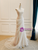 Side view of lightweight white tulle sheath wedding dress with floor-length hem