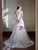 Bride wearing white tulle v-neck wedding dress with appliqués and floor-length hem