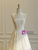 Close-up of intricate floral lace overlay on a wedding dress bodice