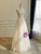 Side view showing the A-line silhouette and graceful fit of a lace wedding gown