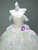 Close-up of layered tulle tiers on a white prom ball gown skirt