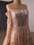 Long sleeve detail on a shimmering orange formal gown
