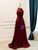Elegant burgundy formal gown with a flowing floor length A line skirt