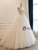 Full front view of the strapless lace wedding dress showcasing the cascading bodice details and the flowing tulle skirt.
