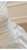 Close-up of the off-the-shoulder neckline and elegant drape of the satin fabric.