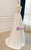 Side/back view showing the corset lace-up back of the white satin wedding dress.