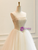 Side/back angle showing the corset lace-up back and cascading tulle layers.