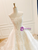 Profile view emphasizing the sweeping cathedral-length train of the outer tulle layer.