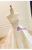 Detail shot showing how the sheer overskirt seamlessly attaches to the structured waistline.
