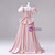 Back view of a pink puff sleeve quinceañera dress with a flowing train and button details