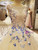 Close-up of butterfly lace appliques and bead details on a tulle A-line evening gown