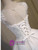 Back view of a white lace-up homecoming dress showing the corset detail