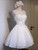 White A-line organza homecoming dress with lace appliques and beading