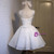 Back view of a white lace-up homecoming dress showing the corset detail