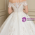 Close up of hand-placed lace appliqués on off the shoulder wedding dress bodice